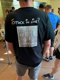 a man in a black t - shirt with the word stuck in line on it