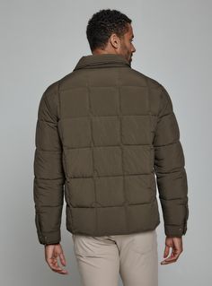 A nylon quilted puffer jacket crafted with recycled fiber insulation fill providing maximum warmth. Features front flap pocket, interior pocket, and hidden phone pocket. Snap closure on cuffs and side vents for comfort. Throw over your favorite flannel for that next-level-cozy feeling. Details Models is 6'1" and wear a size medium. Machine wash cold with similar colors, do not bleach, tumble dry low, do not iron, do not dry clean. 100% Nylon Solid Down Outerwear With Padded Collar, Casual Duck Down Outerwear With Padded Collar, Khaki Puffer Jacket With Pockets For Cold Weather, Duck Down Puffer Jacket With Pockets, Solid Quilted Down Outerwear, Weatherproof Khaki Nylon Outerwear, Casual Duck Down Outerwear With Pockets, Functional Quilted Jacket With Padded Collar For Fall, Khaki Quilted Jacket With Pockets For Cold Weather