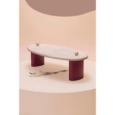 a white and red table sitting on top of a pink wall next to a pair of scissors