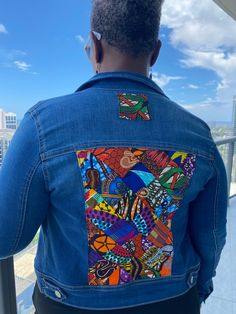 One of a kind upcycled Denim Jacket.  Beautiful African print fabrics pieced together for a quilted look.  The design is on the left pocket and  continues on the back of the jacket.  The pattern is multiple squares for a beautiful design (Color family will be simple but fabric designs may vary).   Size & Information: **Available in multiple sizes. Please message seller for sizing.  Each Jacket is custom made it will be be 3 weeks before you jacket ships. Seller will keep you updated. Multicolor Patchwork Cotton Denim Jacket, Multicolor Cotton Patchwork Denim Jacket, Fitted Recycled Denim Outerwear With Patchwork, Fitted Patchwork Outerwear In Recycled Denim, Fitted Patchwork Denim Jacket In Recycled Denim, Patchwork Jackets For Women, Quilted Denim Jacket, Custom Jean Jacket, Upcycled Denim Jacket