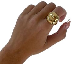 a woman's hand with a gold ring on it