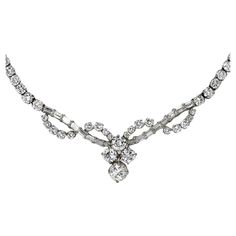 Ladies diamond necklace in 18k white gold setting. Stamped 18k and weighs 22 grams gross weight. Most of the diamonds are round brilliant with a few baguette cuts. The center diamond is .95 carats, J to k color Si2 clairity. The other three side diamonds average H color, VS clarity, .42ct, .46ct, .48ct. The small diamonds average G,H, i color, mostly VS clarity with a few Si clarity. There is approximately 6.50 total carats of smaller diamonds, 8.81 carats for the whole necklace. The necklace me White Gold Diamond Necklace, White Diamond Necklace, Diamond Drop Necklace, Gold Heart Bracelet, White Gold Pendant Necklace, Modern Bracelets, Gold Diamond Necklace, Bezel Set Diamond, Women Diamond