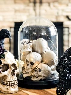 halloween decor with skulls in a glass dome