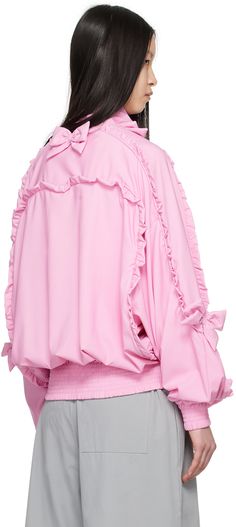 Nylon broadcloth jacket. Bow accents, piping, and ruffled trim throughout. · Stand collar · Zip closure · Elasticized hem and cuffs · Dolman sleeves · Full mesh lining Supplier color: Pink Pink Ruffled Long Sleeve Outerwear, Functional Pink Nylon Windbreaker, Oversized Pink Acrylic Outerwear, Oversized Pink Single-breasted Outerwear, Pink Single-breasted Long Sleeve Outerwear, Pink Long Sleeve Puffer Jacket With Zipper Closure, Pink Body, Pink Doll, Dolman Sleeve