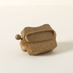 a small wooden object sitting on top of a white table