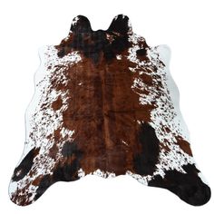 a brown and white cowhide rug on a white background