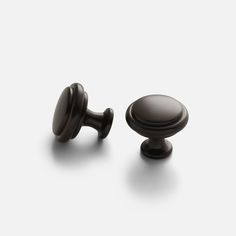 two dark brown knobs on a white background