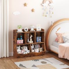 a bedroom with a wooden bookcase filled with stuffed animals