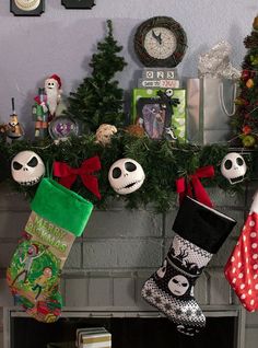 christmas stockings are hanging on the mantle in front of an assortment of holiday related items