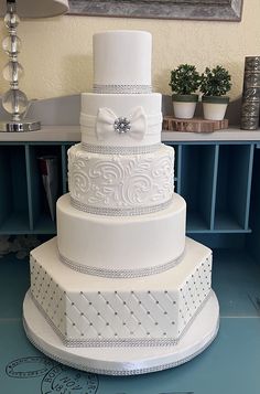 a large white wedding cake sitting on top of a table