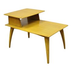 a small wooden table with an open shelf on it's top and one drawer at the bottom