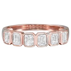 a rose gold ring with five baguets on the side and three diamonds in the middle