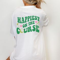 Looking for a cute golf gift? So glad our adorable happiest on the course golf tshirt for women caught your eye! These make the perfect gift for your favorite golfer (or for yourself, of course!)  SIZING: These are unisex shirts and run slightly larger/longer for women. Please review the size guide in listing photos for specific sizing information. To achieve the oversized look pictured, size up 1-2 depending on the look you're going for; again, please reference the size chart in the listing pho Cute Golf Shirts Women, Green Letter Print T-shirt For Golf, Casual Summer Golf T-shirt, Green Golf T-shirt With Letter Print, Golf Shirts Women, Women's Golf Fashion, Golf Shirt Women, Golfer Gifts, Golf Tshirt