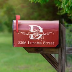 a red mailbox sitting on top of a wooden post