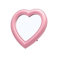 a pink heart shaped mirror on a white background