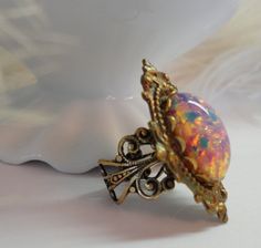 Ring Opal Gothic  Pink Fire Opal Cameo Antiqued  by crushjewels, $35.00 Vintage Opal Ring As A Gift, Vintage Gold Opal Jewelry, Vintage Opal Ring Gift, Vintage Gold Opal Cabochon Ring, Vintage Gold Opal Ring Gift, Vintage Round Cabochon Opal Ring, Vintage Gold Opal Ring For Gift, Vintage Opal Cabochon Ring For Collectors, Vintage Oval Cabochon Opal Ring