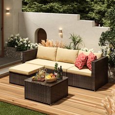 an outdoor living area with couches and tables