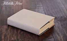 an open book sitting on top of a wooden floor