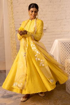 Lemon yellow organza jacket with floral embroidered motifs and front tassel tie-up. Paired with Chanderi sleeves, mukaish work anarkali and Chanderi pant, organza dupatta.
Component: 4
Embroidered
Neckline: Mandarin
Sleeve Length: Full
Fabric: Shantoon, Organza,Chanderi Mukaish, Chanderi
Color: Yellow
Gota, muskaish work
Striped pant
Tassel dupatta
Scallop border - Aza Fashions Bollywood Style Long Sleeve Sharara In Organza, Long Sleeve Organza Choli With Zari Work, Festive Long Sleeve Tissue Silk Anarkali Set, Long Sleeve Tissue Silk Anarkali Set With Resham Embroidery, Yellow Organza Kurta For Festivals, Bollywood Style Tissue Silk Anarkali Set With Long Sleeves, Transitional Anarkali Set With Sheer Dupatta In Organza, Bollywood Style Long Sleeve Tissue Silk Anarkali Set, Chanderi Wedding Dress With Gota Work