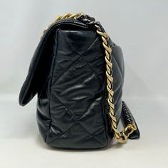 Chanel Maxi 19 Flap Bag with Bi-colored Chain Link Shoulder Strap, Interlocking CC Logo and Quilted Pattern (includes Dustbag) Designer = Chanel Color = Black Material = Lamb Skin Condition = Excellent Height = 10 Width = 14 Depth = 4.5" Class = Premier Location: Wilmette Item Number: 20201-73 Item ID: 300893 Category: Shoulder Bag Black Formal Bag With Cc Turnlock Closure, Formal Black Bag With Cc Turnlock Closure, Elegant Black Flap Bag With Cc Turnlock Closure, Luxury Everyday Black Shoulder Bag With Cc Turnlock, Black Satchel Bag With Cc Turnlock Closure, Luxury Black Double Flap Bag, Gold Double Flap Evening Bag, Luxury Black Flap Bag With Cc Turnlock Closure, Everyday Luxury Bag With Chain Strap And Double Flap