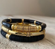 Set of 3 bangle stretch bracelets, black and gold plated spacers. Gorgeous set!  Sizes small 6.5 Medium 7 Large 7.5 Black Metal Bangles, Black Metal Bracelet, Bracelets Heishi, Black And Gold Bracelet, Black Bangles, Tube Bead Bracelet, Clay Bracelets, Heishi Bracelet, Acrylic Bracelet