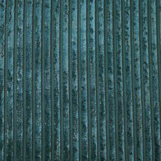 the texture of an old metal sheet is shown in this close up photo, with blue and green stripes on it