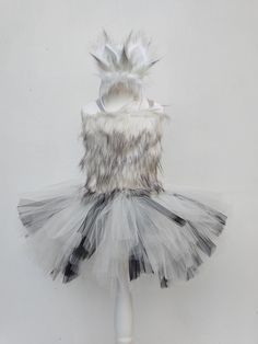 a white and black tutu skirt on top of a mannequin headdress