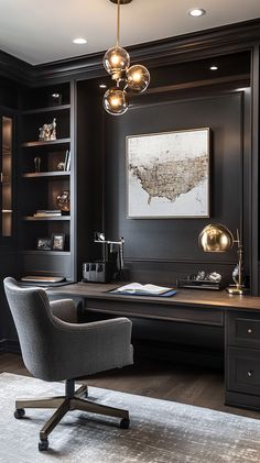 a home office with black walls and wooden flooring, along with a gray upholstered chair