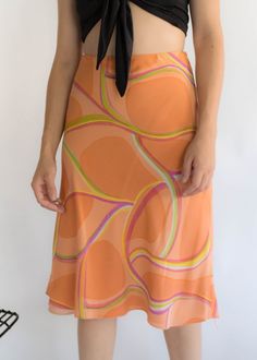 "Vintage 90s abstract silk skirt. Brightly colored abstract silk skirt perfect for the Spring / Summer season! Low-waisted fit. Flowy a-line silhouette. Below knee length. Side hook and eye and zipper fastening. Fully lined. We kindly ask that you please view all measurements for comparison so you can get your desired fit. Made in New York. * Brand: Lafayette New York 148 * Decade: 1990s * Fabric: Silk * Lining: Polyester Crepe * Color: Orange, Lime Green, Pink C O N D I T I O N Excellent vintag Summer Flowy Skirt With Abstract Print, Fitted Skirt With Retro Print For Spring, Lafayette New York, Spring Abstract, Fabric Silk, Low Waisted, Model Fits, Silk Skirt, Puff Sleeve Top