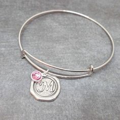 High-quality stainless steel bangle with initial pendant and Swarovski crystal birthstone of your choice!  Thick wire silver bangle is adjustable for any wrist size and super comfortable.  A classic look for everyday wear. This is an AMAZING deal!! Wonderful gift for birthdays, Valentine's, bridesmaids, new mothers, etc. Each bracelet comes with a free gift box.  Initial charms are in the style of antique wax seals used to close envelopes or love letters.   The wax seal pendant is silver plated Nana Jewelry, Wax Seal Pendant, Initial Charm Bracelet, Family Bracelets, Personalised Bangle, Bracelet Initial, Antique Wax, Birthstone Bracelet, Stainless Steel Bangles