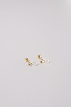 PLX437 Our XXS CZ Heart and Pearl Screw Back Earrings are meticulously handcrafted in Korea. They beautifully blend classic and contemporary style, making them a unique piece of jewelry. Made from 14K solid gold, studded with cubic zirconia in a heart shape and adorned with pearls, these earrings not only offer durability but also emanate a sophisticated charm. Their screw back design ensures a secure and comfortable fit, perfect for adding a delicate and elegant touch to your everyday look or f Elegant Everyday Heart Earrings, 14k Gold White Heart Earrings For Gift, White 14k Gold Heart Earrings Gift, Elegant 14k Gold Earrings With Heart Charm, Elegant 14k Gold Double Heart Earrings, Formal Heart-shaped Pearl Drop Earrings, Elegant Yellow Gold Teardrop Heart Earrings, Formal Pearl Drop Heart Earrings, White Double Heart Classic Jewelry