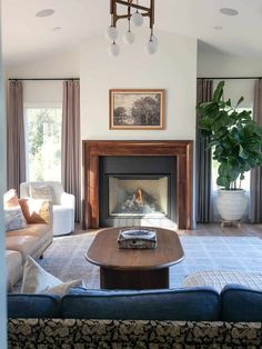 a living room filled with furniture and a fire place in the middle of a room