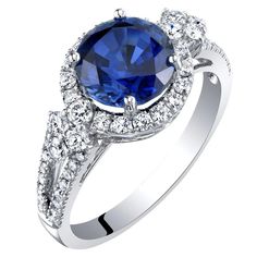 This 14k white gold cornflower blue sapphire halo ring bask in a timeless look with an array of lab grown diamonds for extra sparkle. Hipster Rings, Gothic Jewelry Rings, Blue Sapphire Halo Ring, Sapphire Halo Ring, Steampunk Rings, Silver Skull Ring, Blue Topaz Bracelet, Contemporary Ring, Sapphire Engagement Ring Blue