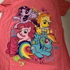 a pink shirt with three ponies on the front and two rainbows on the back