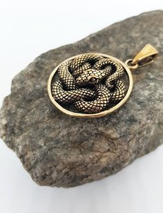 This item is made to order. Casting in any metal will take 14-19 days. Please, leave your orders.Astonishing snake pendant, unisex. Bronze or silver, with or without leather cord.Size - 1 inches / 2,6 cmWeight for bronze -  5,8 g.Weight for silver -  7,1 g.✤ If you have any questions - feel free to ask! Spiritual Metal Jewelry In Snake Shape, Spiritual Snake-shaped Metal Jewelry, Bronze Tarnish Resistant Pendant Jewelry, Bronze Tarnish-resistant Pendant Jewelry, Symbolic Snake-shaped Brass Jewelry, Engraved Metal Snake-shaped Jewelry, Bronze Snake-shaped Jewelry Gift, Bronze Snake-shaped Jewelry For Gift, Bronze Snake Shape Jewelry As Gift