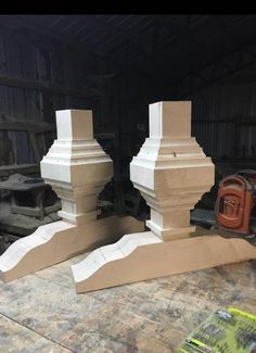 two wooden pillars sitting next to each other on top of a table in a garage