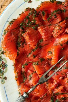 a white plate topped with salmon covered in sauce