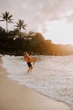 a woman is running into the water at the beach