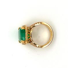 "I'm crazy about this Emerald ring! It is a 9.05ct Natural Emerald, with a square Emerald shape. The setting features a split shank with a halo, which follows the cut corners of the emerald. Crafted in 18K yellow gold and holds one carat of G color, VS2 clarity diamonds. The profile of the basket boasts 5 cut outs which allows optimal light to the bottom of the stone. The vibrant green glows through the basket and casts a beautiful color onto the skin. Details: Bottom of shank is 4.4mm the halo Gia Certified Gold Rings For May Birthstone, Unique Gold Rings With Halo Setting, Perfect Imperfection, Smaragd Ring, Skin Details, Blue Green Sapphires, Split Shank Ring, I'm Crazy, Emerald Color