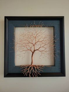 a tree is shown in a frame on the wall