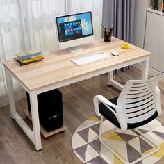 a desk with a computer on top of it and a chair next to it in front of a window