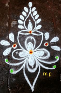 a white flower painted on the ground with words written in yellow and green marker markers