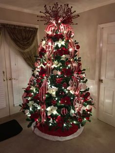 a decorated christmas tree with red and white lights