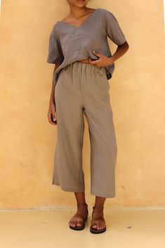 The linen culottes with an elastic waist offer a comfortable fit and a breezy, stylish look. Handcrafted in our studio to your measurements and preferences, available in over 60 colors. STYLE DETAILS - 100 % linen, medium weight (200gsm), free-shrinkage, amazingly soft feel - Ankle length pants; different length is possible - High waisted - Wide-legs - Elastic waistband - Inseam pockets - Pants inseam 22''/55cm and pants outseam 32.3''/82cm/size S for our lovely model 5ft5/169cm tall. - Leg open Relaxed Fit Wide-leg Summer Capris, Summer Wide Leg Relaxed Fit Capris, Wide Leg Relaxed Fit Summer Capris, Wide Leg Relaxed Fit Capris For Summer, Effortless Ankle-length Summer Pants, Summer Loungewear Solid Color Wide Leg Pants, Wide Leg Summer Loungewear Pants, Summer Linen Wide Leg Pants In Solid Color, Solid Color Wide Leg Pants For Summer Loungewear