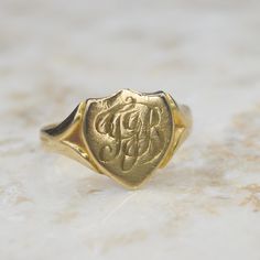 Antique late Victorian signet ring in a buttery 18k gold. The shield-shaped face is hand-engraved with the initials T.J.B. Fully hallmarked for Chester, England 1904. Era: Dated 1904 Markings: British hallmarks for 18k Chester 1904 Materials: 18k gold Ring Size: 9 (Comes with one free resizing by our jeweler) Weight: 4.0 grams Face measures 12.77 mm from north to south Condition: Excellent antique condition with minor surface wear from  Shipping is free in the United States Follow us on Instagram @LUXXORVintage Chester England, Gold Signet Ring, 18k Gold Ring, Hand Engraving, Signet Ring, Rings Statement, Gold Ring, Hallmark, Favorite Jewelry