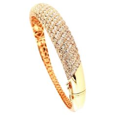 Design: Elevate your wrist with this breathtaking diamond classic bangle, an embodiment of timeless beauty and contemporary style. Fashioned in lustrous 18K rose gold, this bangle showcases a classic design adorned with a profusion of brilliant diamonds. Material: The bangle is expertly crafted from high-quality 18K rose gold, infusing warmth and romance into the piece. Rose gold's unique hue complements the diamonds, creating a harmonious and alluring combination that adds a touch of sophistica Diamond Bangle In Rose Gold With Pave Setting, Rose Gold Diamond Bangle With Pave Setting, Luxury Diamond Cut Bangle Bracelet, Luxury Bangle Diamond Bracelet With Diamond Cut, Rose Gold Bangle With Pave Setting, Luxury Brilliant Cut Diamond Bangle Bracelet, Rose Gold Brilliant Cut Bangle For Weddings, Wedding Rose Gold Bangle With Brilliant Cut, Wedding Rose Gold Brilliant Cut Bangle