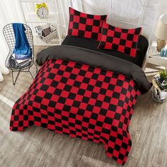 a red and black checkered comforter set on a bed