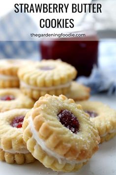 strawberry butter cookies on a plate with jam in the background and text overlay that says strawberry butter cookies