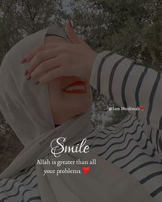 a woman wearing a hijab and holding her hand up to her face with the words smile