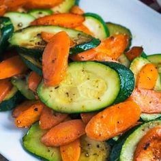 a white plate topped with cucumbers and carrots